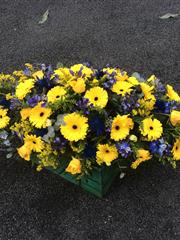 Yellow and blue double ended casket spray 